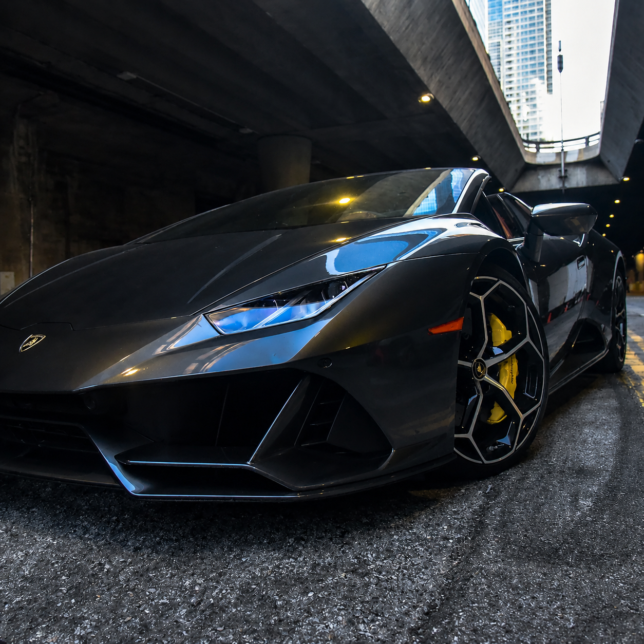 Exotic supercar on a mountain road at dusk